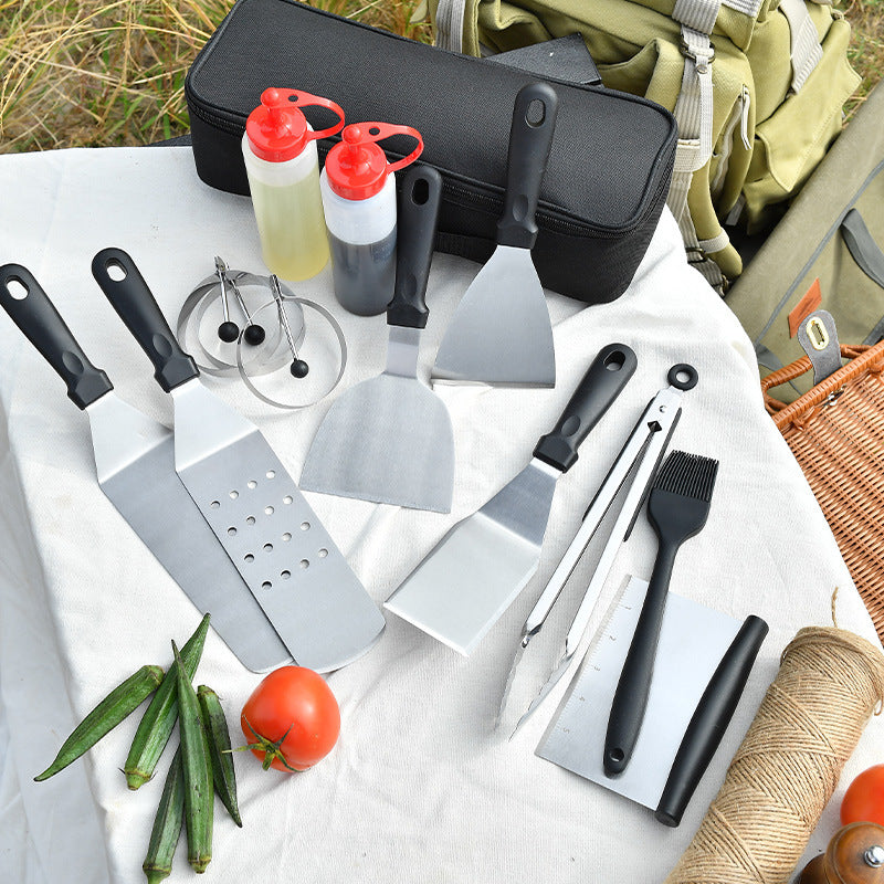 Complete BBQ Kit: Displaying a complete BBQ kit, this image shows a set of stainless steel barbecue tools along with a durable storage bag, perfect for outdoor cooking.