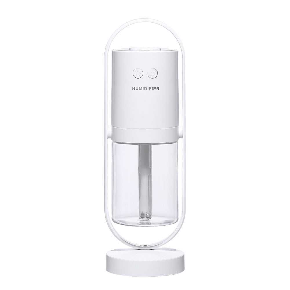 A cylindrical white USB air humidifier with a transparent water tank is cradled in a metallic arc stand.