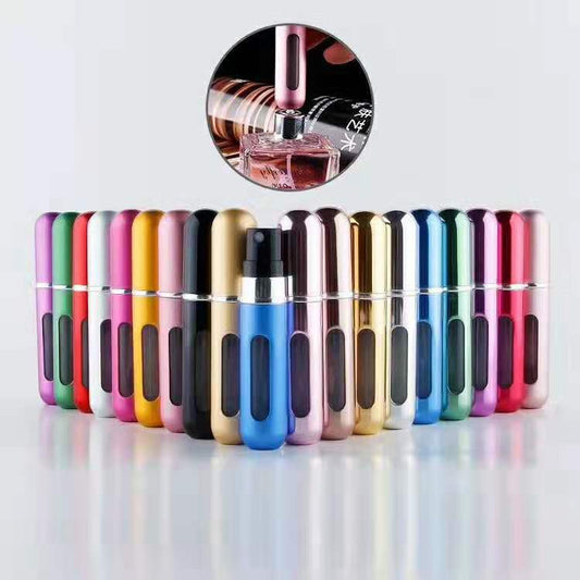 The image displays a collection of sleek, cylindrical mini portable perfume atomizers in a rainbow array of colors. Each atomizer has a transparent window to monitor the perfume level, and a nozzle for easy spray application, as depicted in a close-up inset showing the atomizer being refilled from a traditional perfume bottle.