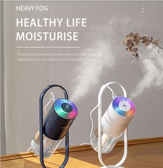 Two air humidifiers, one in black and one in white, producing a heavy mist, with the text "HEALTHY LIFE MOISTURISE" emphasizing their purpose.