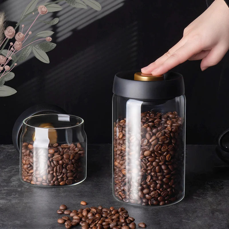 Vacuum Sealed Glass Canister: The Vacuum Sealed Glass Canister filled with coffee beans is shown with its lid open, highlighting its vacuum sealing feature that keeps coffee fresh for longer.