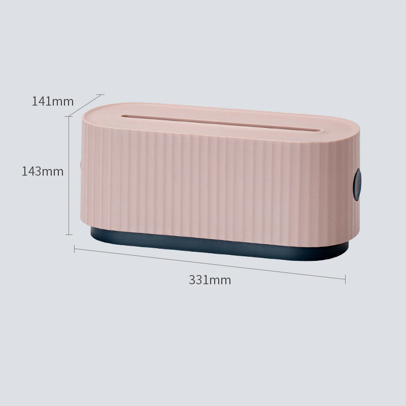 The Cloud Power Storage Box is shown in a soft pink hue, positioned in a modern setup that underlines its function as a charger case and power strip cover, essential for dust-free cable and charger management.