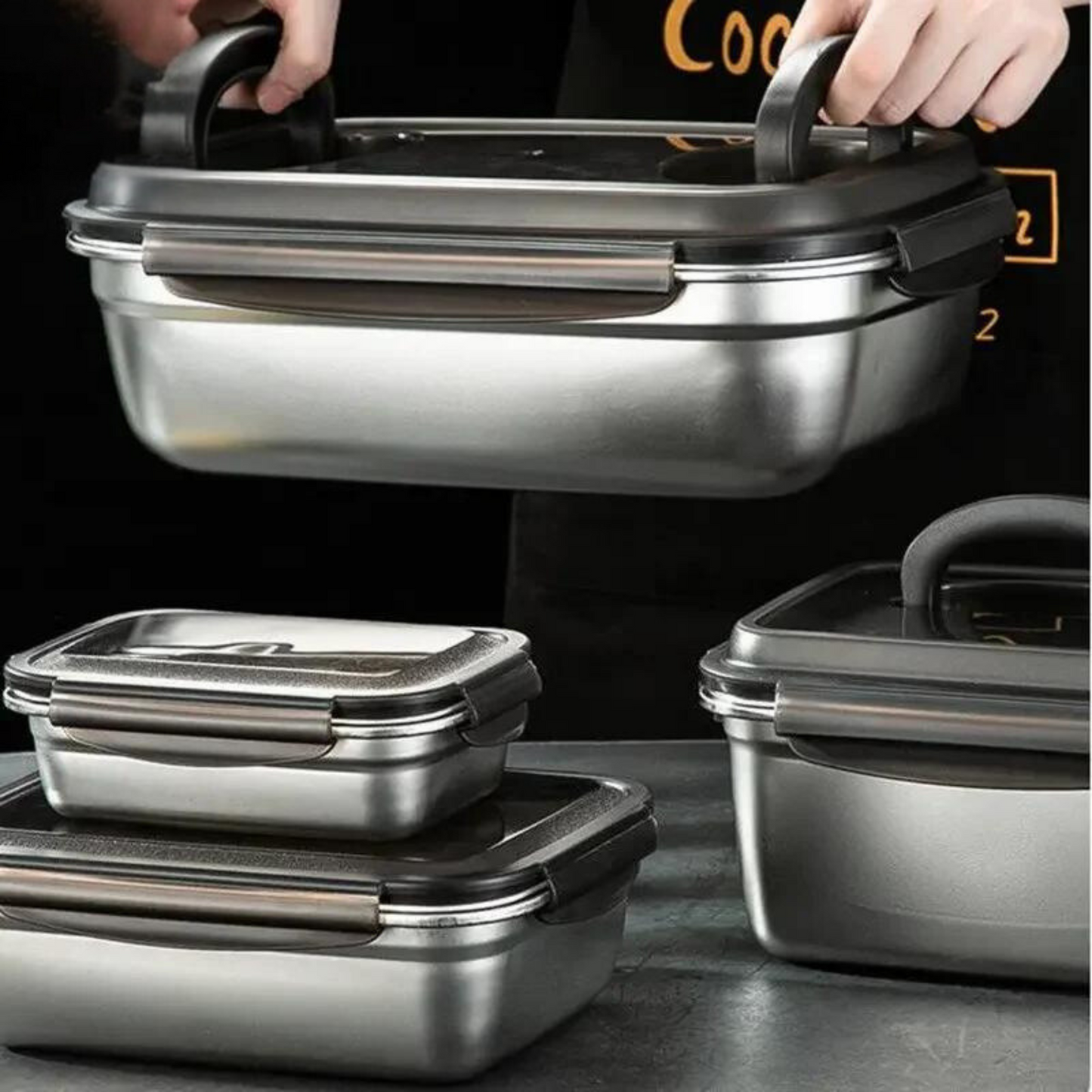 Large Capacity Stainless Steel Outdoor Portable Lunch Bento Box: A person holding a large stainless steel lunch bento box, displaying its sturdy and durable build. This image highlights the box's thermal insulation properties.