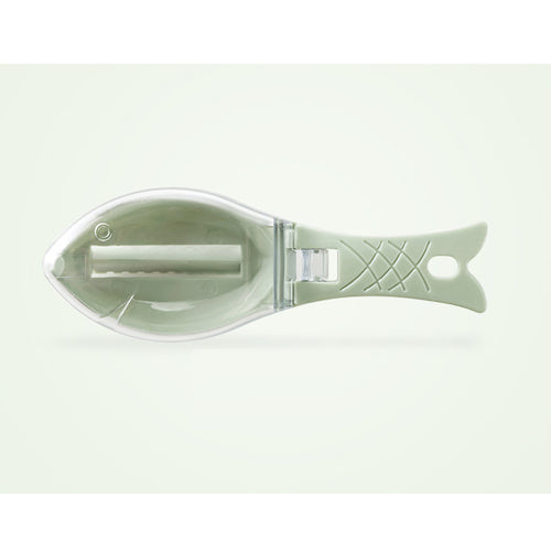 A standalone image of the fish-shaped scale remover in green, with its cover closed, highlighting its compact design.
