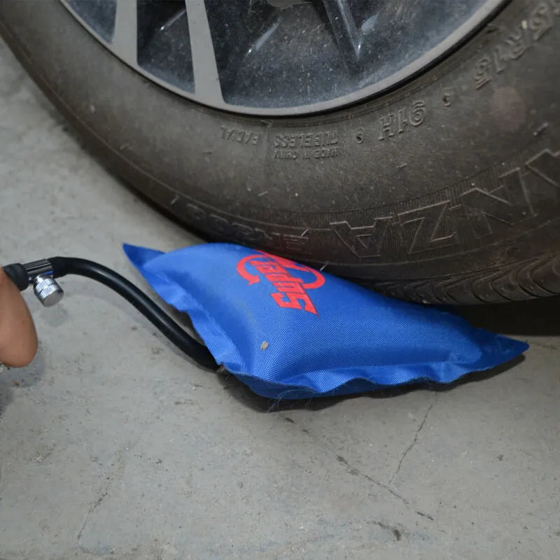  a Super PDR Pump Wedge is positioned under a car tire, illustrating its potential to adjust and level heavy objects.