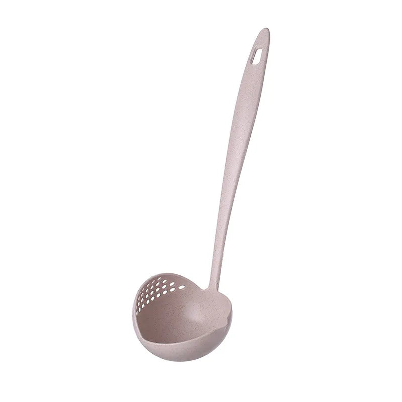 A side view of the same pastel pink soup spoon ladle, showing the rounded bowl with strainer holes on one side and a long, slender handle,