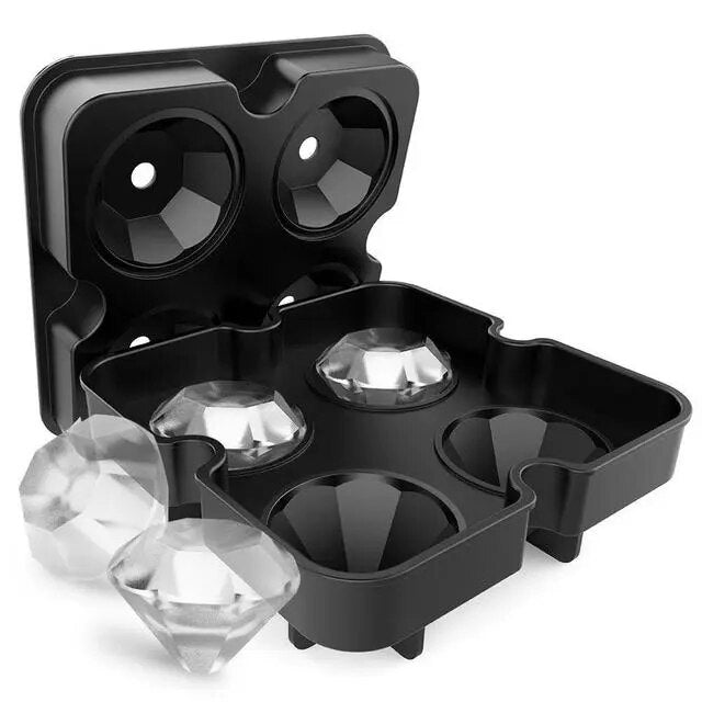 A black silicone ice cube tray with four large diamond-shaped molds, with diamond-shaped ice.