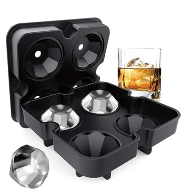 A black silicone ice cube tray with four large diamond-shaped molds, pictured alongside a glass of whiskey with diamond-shaped ice.