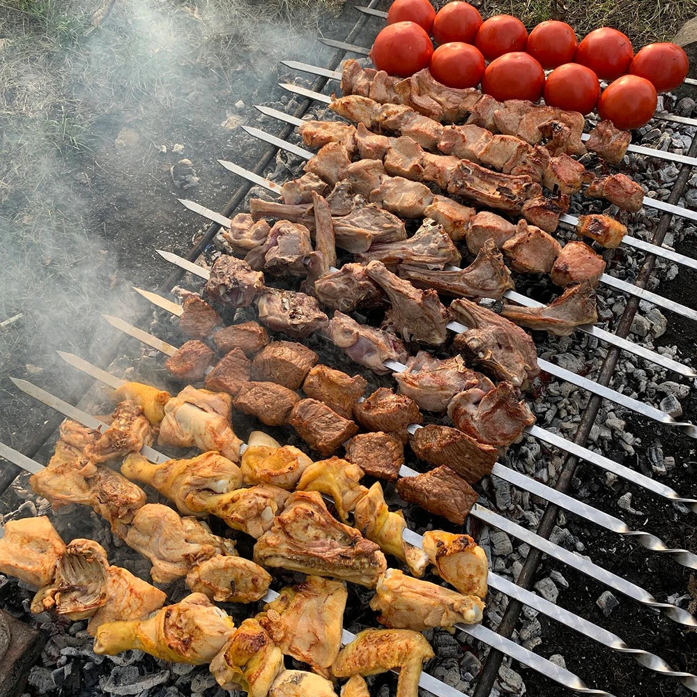 Grilling in Action: Barbecue skewers in use on a grill, loaded with meat and vegetables, demonstrating their effectiveness and even cooking capabilities