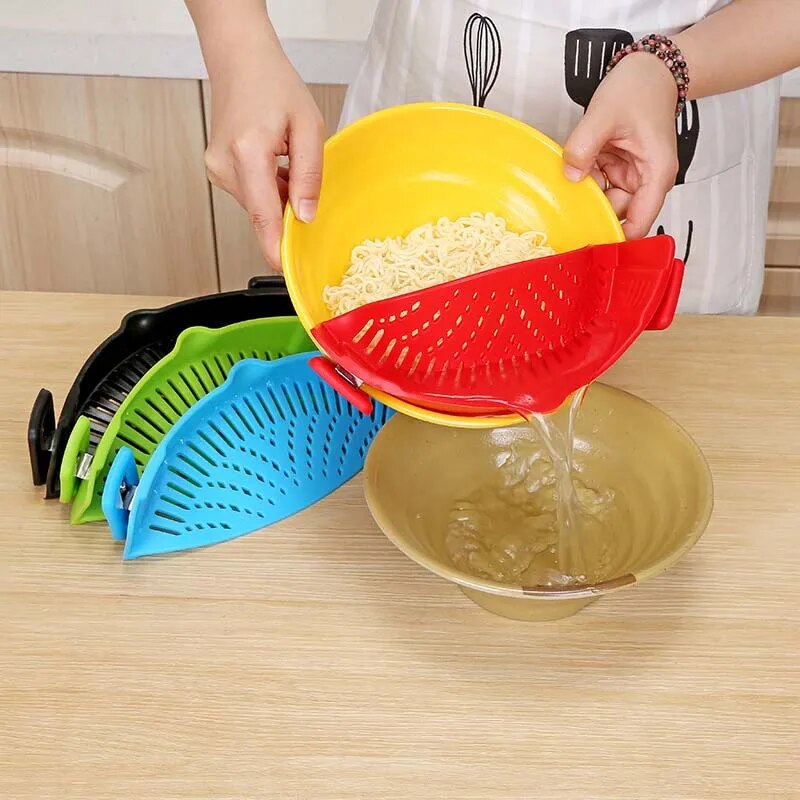 A person is using a yellow silicone strainer to pour liquid from a bowl, showcasing its versatility