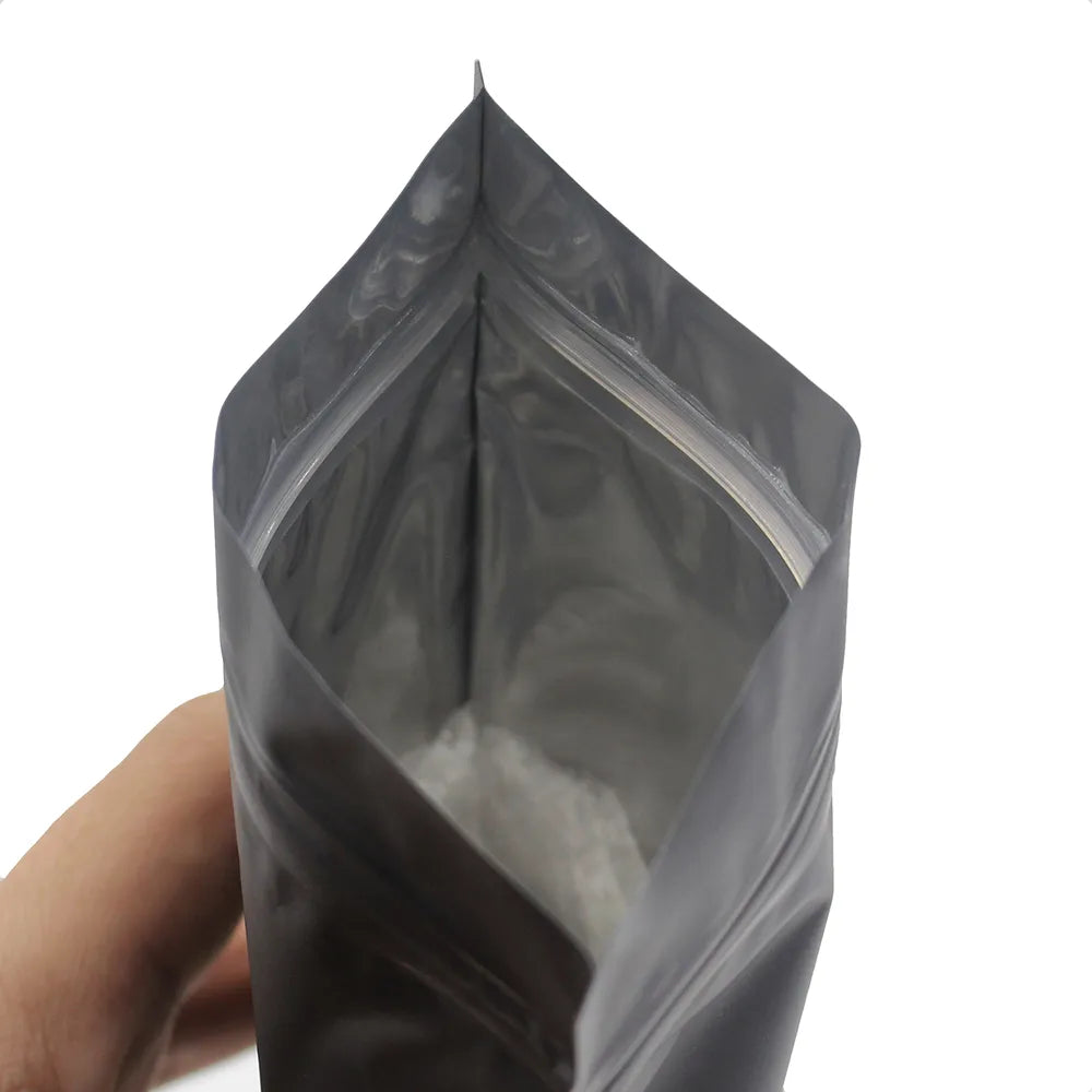 An open Resealable Coffee Herb Powder Zipper Pack Bag is shown, revealing the mylar material inside that contributes to its moisture and odor-proof qualities.