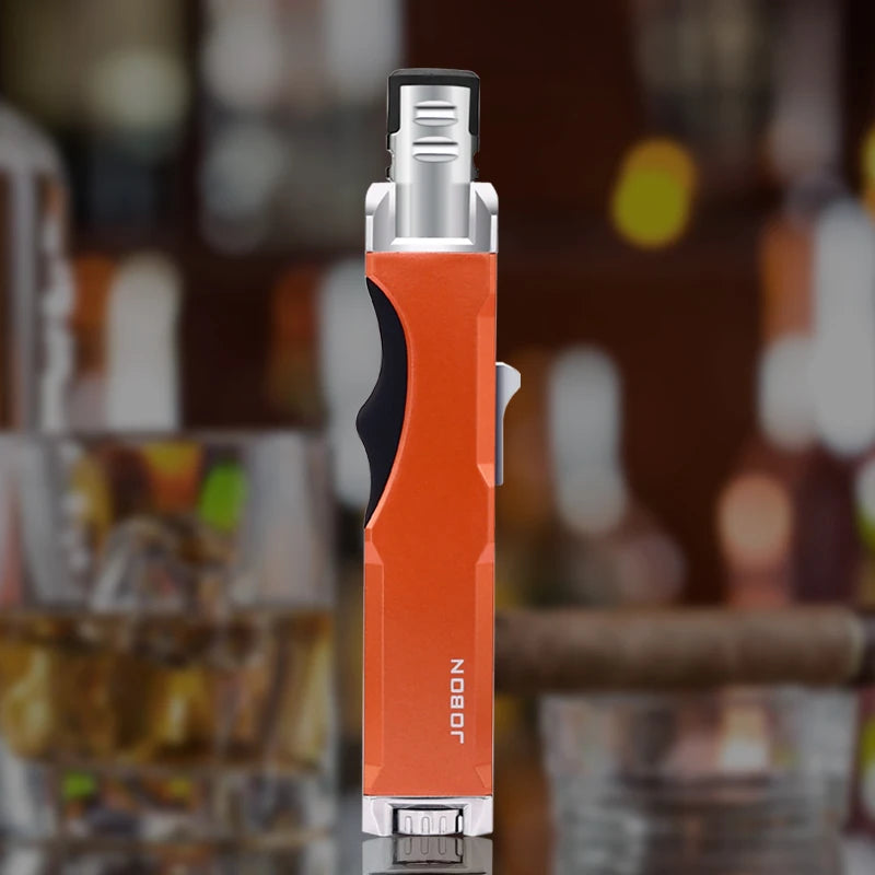 The orange windproof torch lighter is placed on a bar counter, illustrating its use for lighting cigars and other needs. The durable butane torch is perfect for any setting.