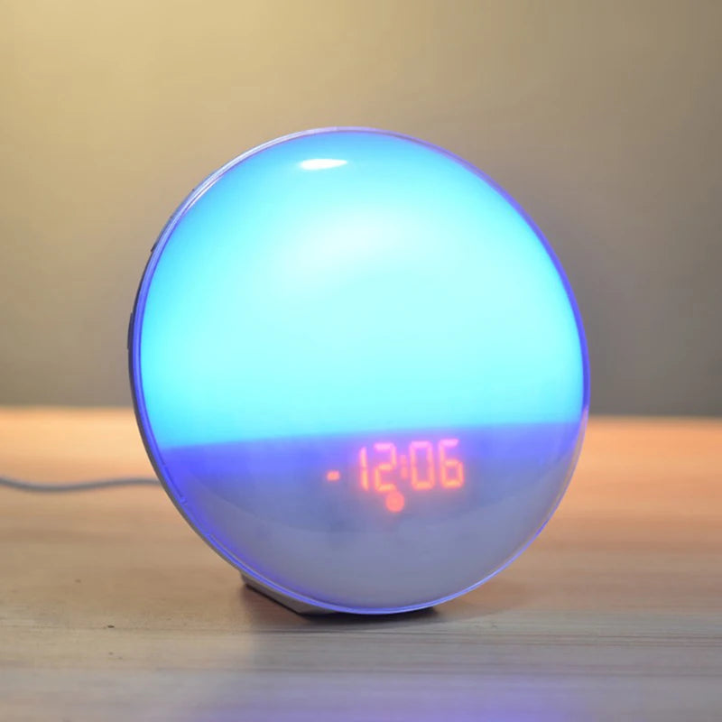 Digital Clock and Colors A blue-lit wake-up light alarm clock showing the time 14:01, illustrating its vibrant color options. Great for modern decor.