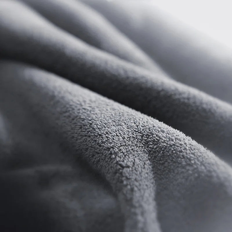 Close-up view of the microfiber towel's soft fabric, highlighting its fine fibers and plush texture.