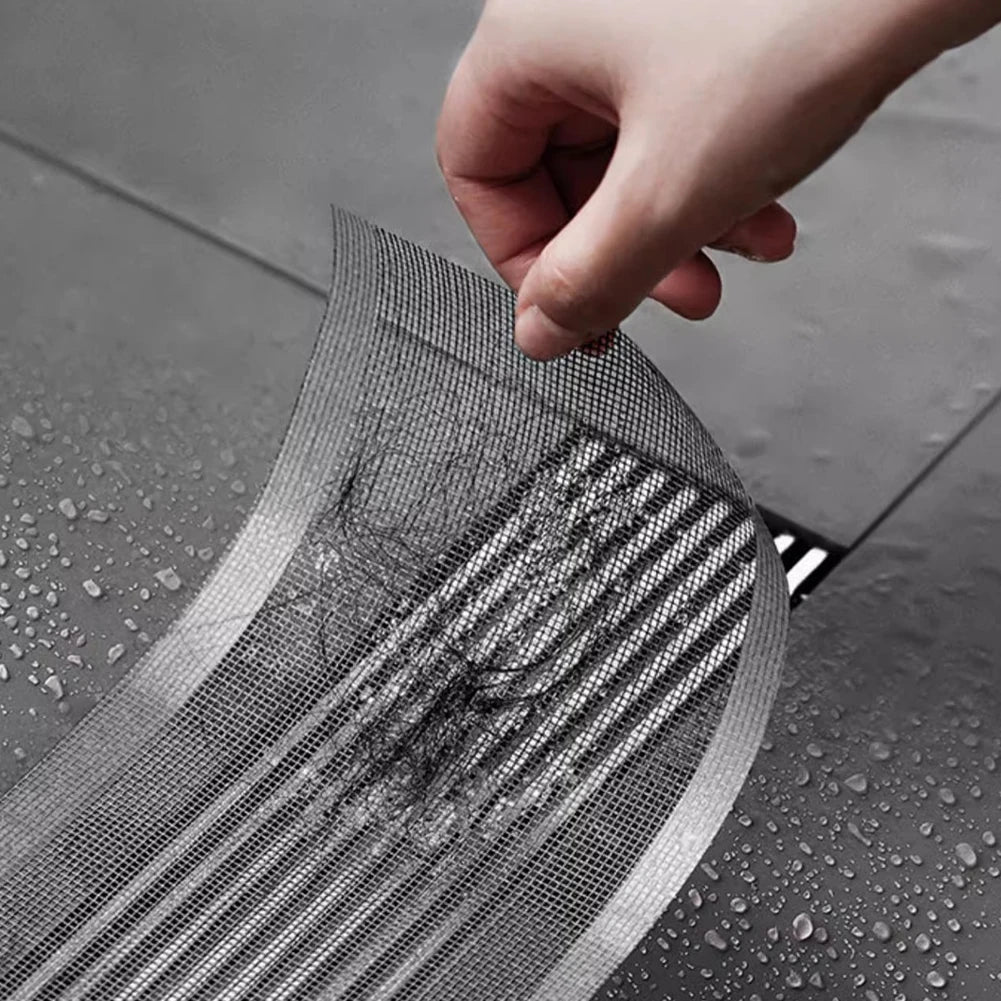 Image 3: Demonstration of how to install the Disposable Shower Drain Hair Catcher on a shower drain. The image shows a hand carefully peeling off the mesh filter filled with hair, illustrating its efficiency in catching debris and keeping drains clean.