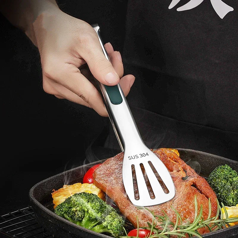Kitchen Clip in Use: The tongs are shown in action, gripping a piece of food securely. The ergonomic design and stainless steel material make them a reliable tool for any kitchen task.