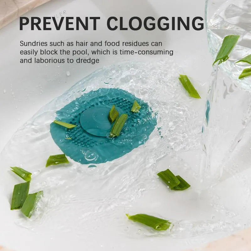 A green silicone strainer is lying on a wet surface surrounded by chopped green vegetables, demonstrating its use in a kitchen sink.
