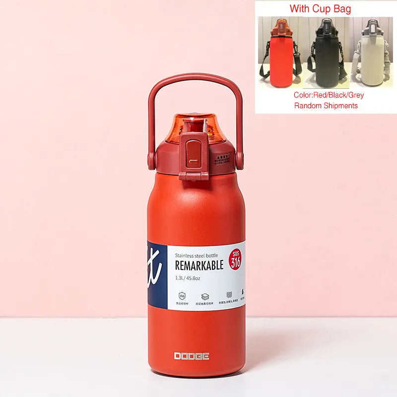 The image displays a red stainless steel thermal water bottle with a sturdy handle on the lid. The bottle is labeled "REMARKABLE 316", indicating the grade of stainless steel, and has a capacity of 1.3L/45.8oz as stated on its label