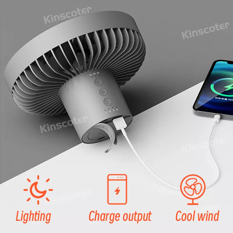 Power Bank Functionality: The fan shown charging a mobile phone, emphasizing its built-in power bank feature, ideal for camping.