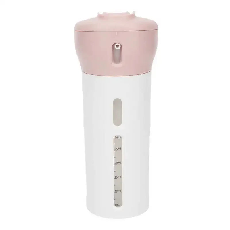 Pink 4-in-1 Portable Travel Liquid Dispenser: Featured here is the dispenser with a soft pink cap, standing vertically. Its clear body section showcases the internal bottles meant for different liquids.