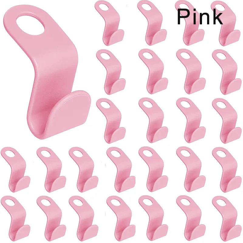 A collection of pink space-saving hanger connectors displayed against a white background, each with a slot for attaching another hanger.