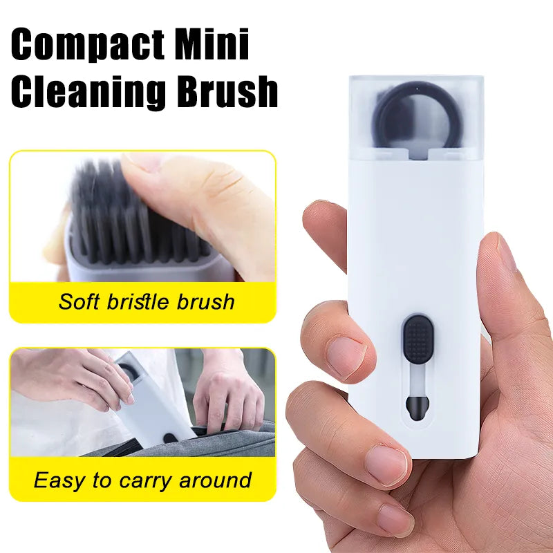 A hand holding a compact mini cleaning brush with a yellow detailing, indicating its soft bristle brush, portability, and ease of use.
