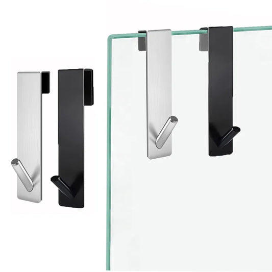 The image shows two modern, metal hooks in silver and black, designed to hang over a shower door's glass panel. The hooks have a straightforward, rectangular form with a subtle S-curve at the end for holding items, blending functionality with a minimalist aesthetic.