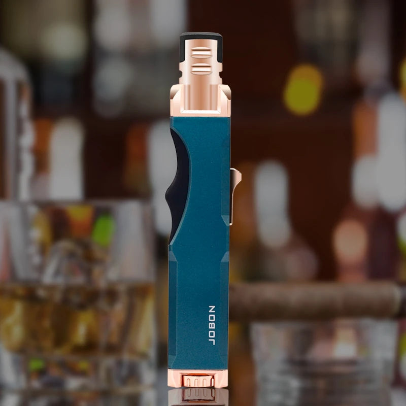 The blue windproof butane torch lighter stands out on a bar counter, showing its sleek design and functionality. Ideal for lighting cigars with precision.