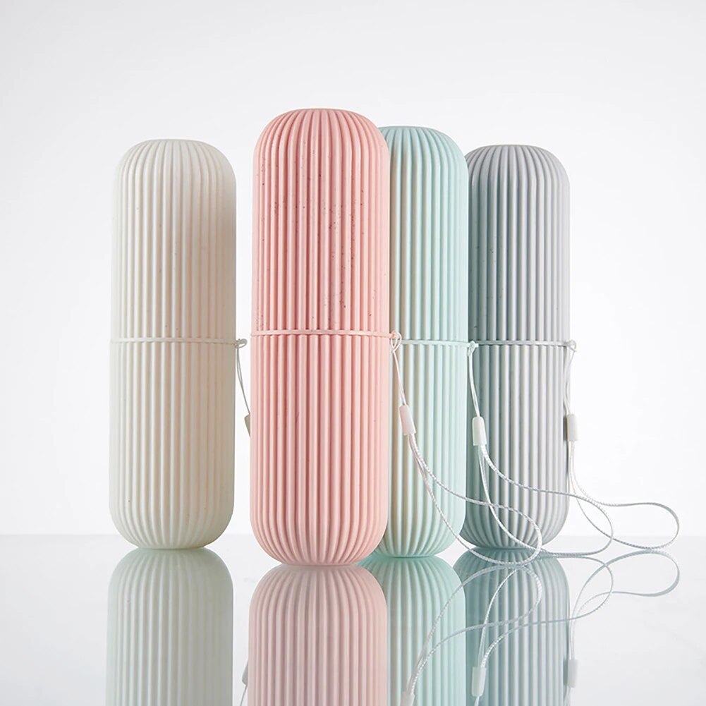An array of four toothbrush cups in soft hues of grey, pink, mint, and blue, presented in a row with their caps on.