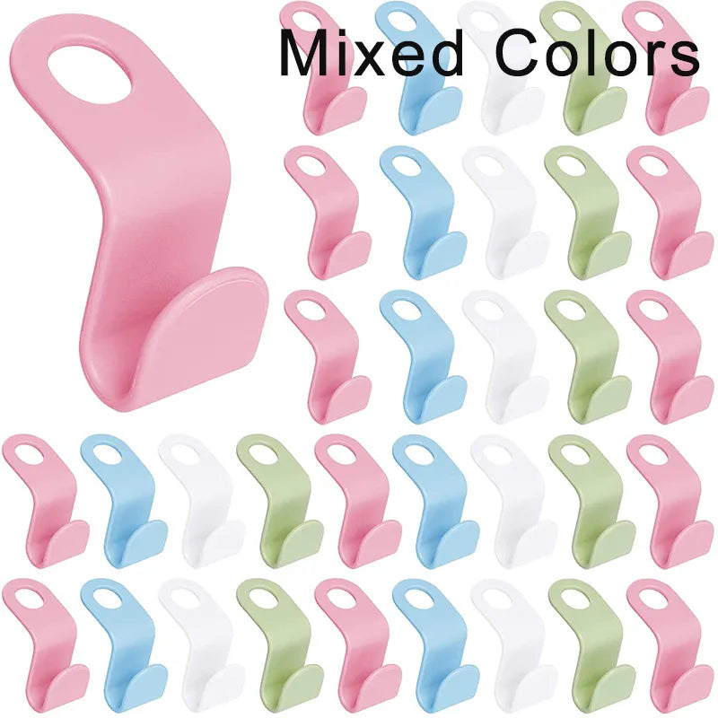 A collection of mixed colors, space-saving hanger connectors displayed against a white background, each with a slot for attaching another hanger.