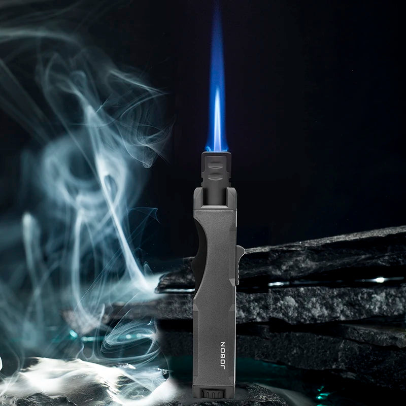 The windproof butane torch lighter emits a bright blue flame, suitable for culinary tasks and outdoor activities. The image highlights its efficiency and reliability.