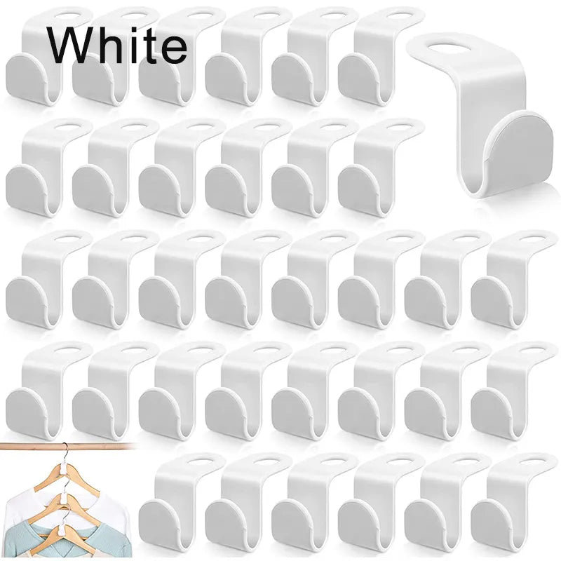 A collection of white, space-saving hanger connectors displayed against a white background, each with a slot for attaching another hanger.