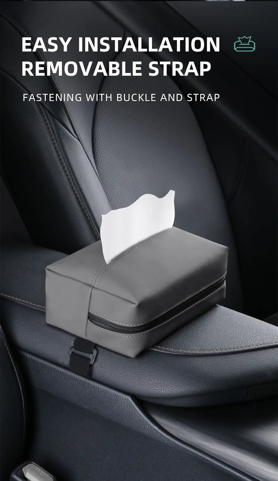  The image displays a sleek, gray Nappa leather car tissue box holder positioned on a car seat. It is secured by a removable strap with a buckle that neatly fits around the seat, ensuring the holder stays in place. The top of the holder is partially open, revealing the white tissues inside, ready for use. The design is minimalist, emphasizing functionality and easy installation in a vehicle's interior.