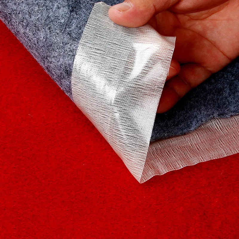 A strip of the tape being removed from a fabric surface, highlighting its traceless removal