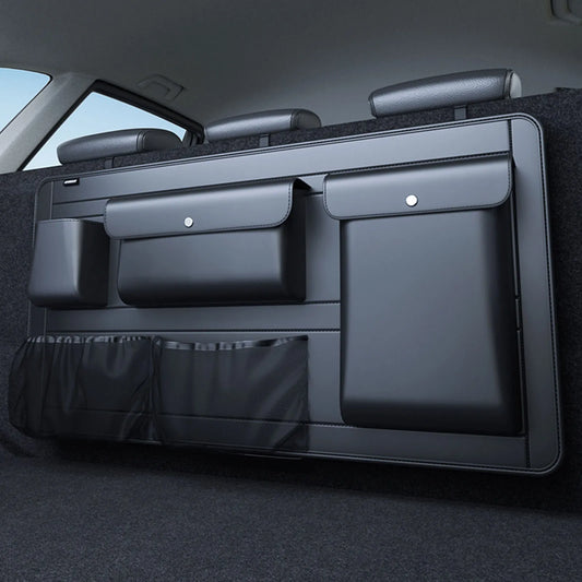 A black PU leather car trunk organizer installed in a vehicle, showing multiple storage compartments and a clean, structured design.