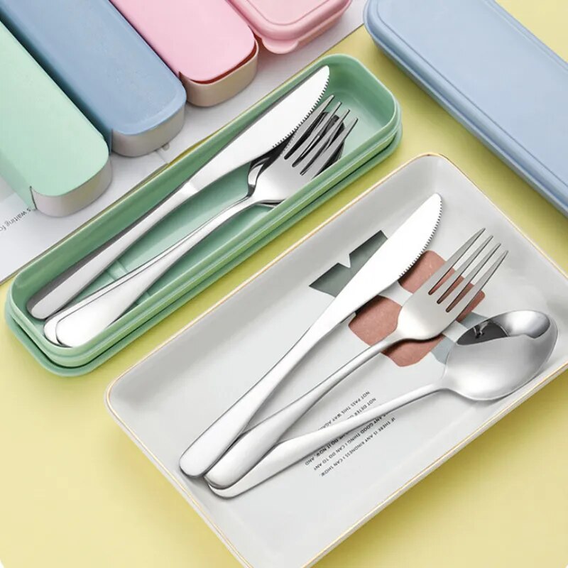 A sleek stainless steel fork, spoon, and knife set arranged neatly in a mint green rectangular storage box with a rounded, snap-on lid.