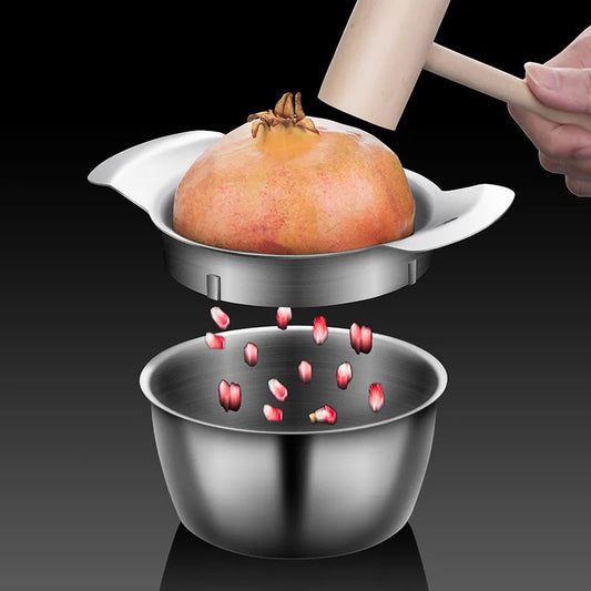 A person's hand holds a halved pomegranate over a bowl with a pomegranate peeling tool, ready to extract the seeds.