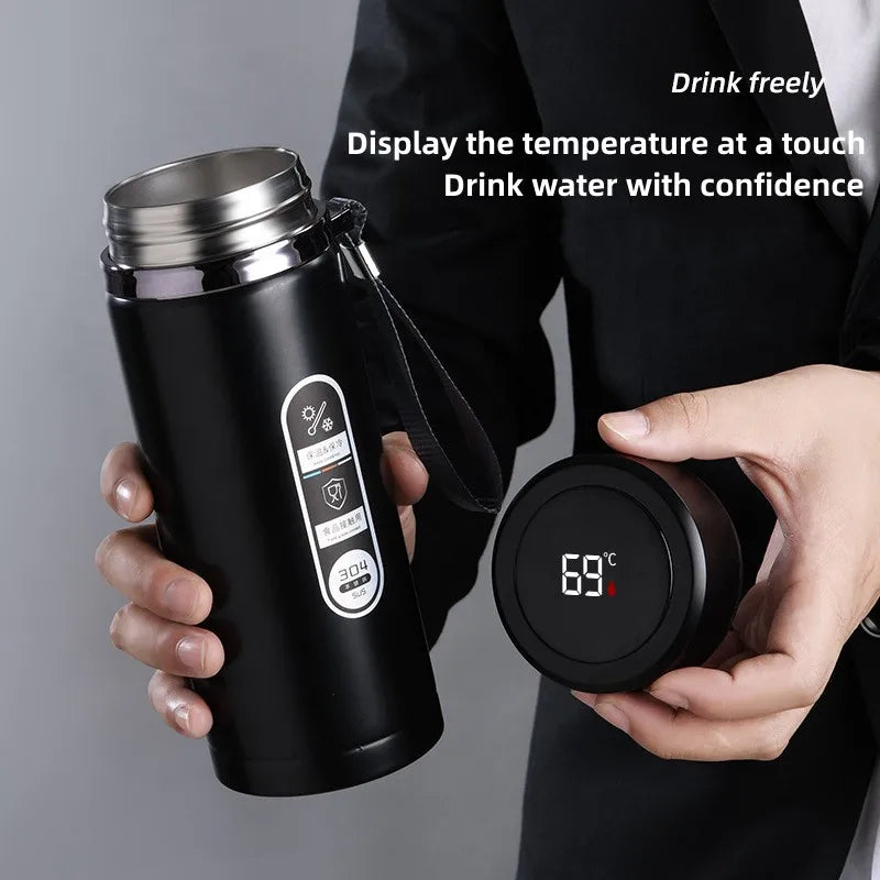 800ML-1 Liter Stainless Steel Thermos Bottle with LED Temperature Display: This image highlights the user holding the bottle, demonstrating the LED display showing the drink's temperature. The bottle's sleek design and ergonomic handle are also visible.