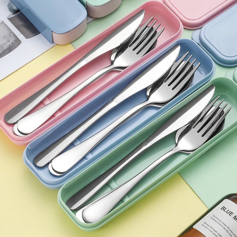 A top view of colorful cutlery sets in pink, blue, and green storage boxes, showcasing a shiny finish and clean lines, indicating a modern and portable design.