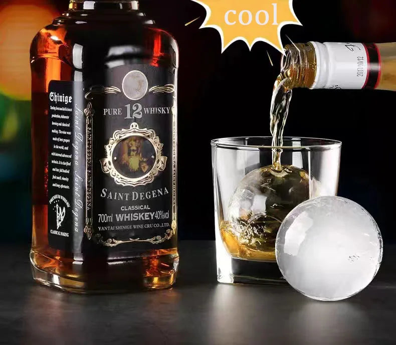 Whiskey and Ice Ball: A whiskey glass with a clear ice ball from the ice ball maker, highlighting the product's effectiveness in enhancing drink presentations.