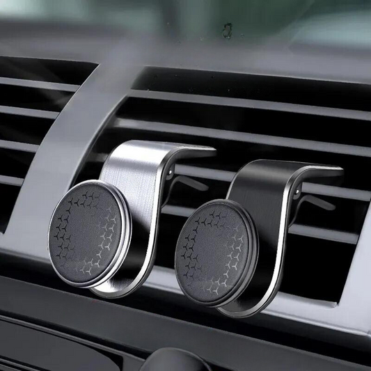 This image shows two sleek metal car phone holders attached to a car's air vent. The holders are described as a "Magnetic bracket stable machine," emphasizing their secure and stable design. Ideal for enhancing your driving experience with elegance and durability.