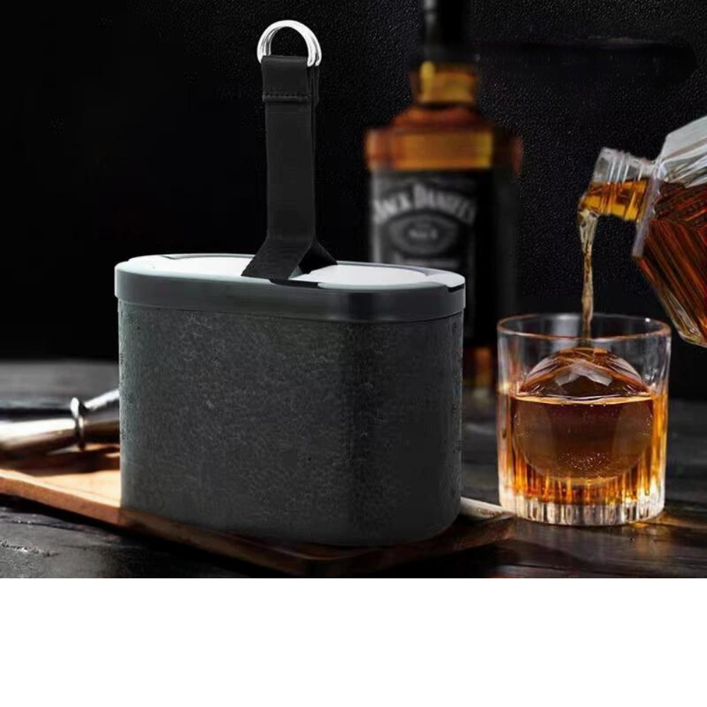 Whiskey Ice Ball Maker: A black ice ball maker mold with a whiskey glass in the background, emphasizing its use for creating elegant, transparent ice balls for drinks.