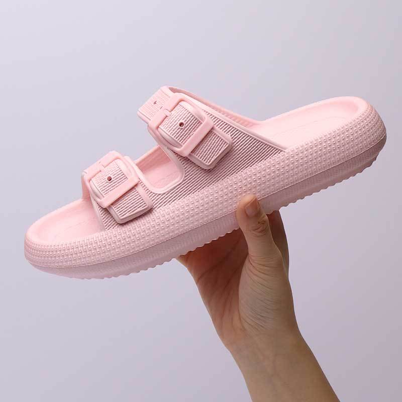 pink platform slippers with buckle straps is displayed, with a focus on the soft texture of the insole.