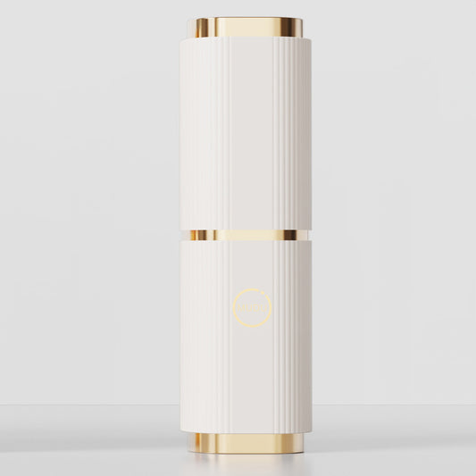 This image displays a fashionable, cylindrical toothbrush case with a luxurious design. It features a sleek white body with vertical ridges and elegant gold accents on the top and bottom. A subtle logo is placed in the center of the case, adding a touch of sophistication. The case is designed for portability and style.