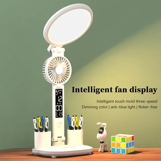 The LED clock table lamp with USB charging is shown on a desk. It features a dimmable light, fan, and pen holder, ideal for office desks and kids desk