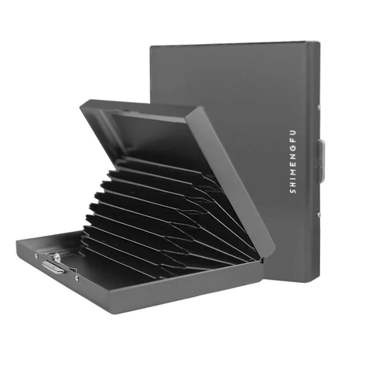 A matte black stainless steel card organizer is partially open, displaying an array of card slots fanned out, with a symbol indicating RFID protection.